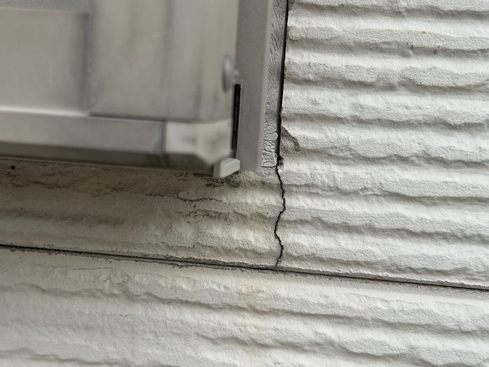 八尾市曙川東のT様邸 窓枠コーナー部分から走るクラック（ひび割れ）のクローズアップ