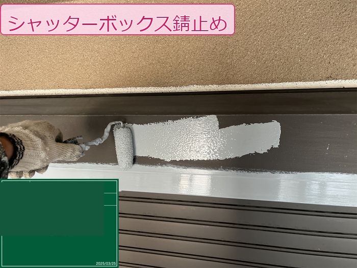 八尾市久宝寺のM様邸 シャッターボックスにローラーで錆止め塗料を塗布している様子