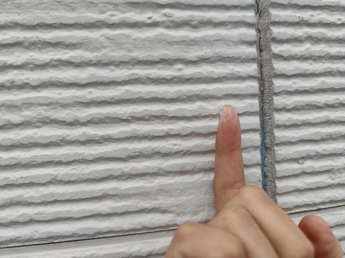 八尾市曙川東のT様邸 劣化したコーキング目地を指差して確認している様子